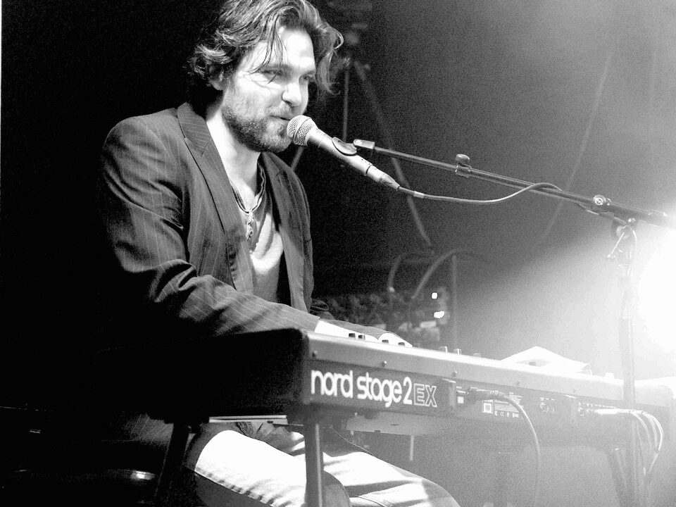 Al Kronka performing solo, playing covers on the piano in an intimate live show.